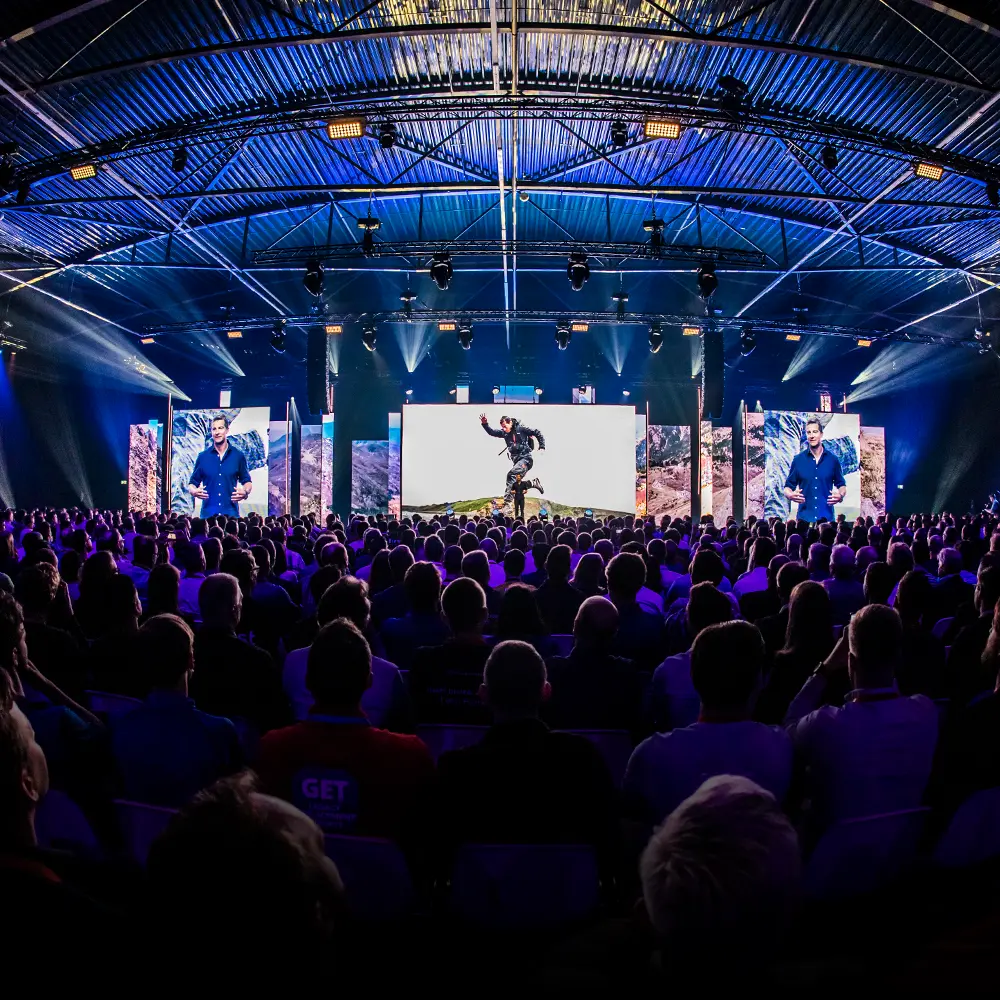 A presentation by Bear Grylls given to a large audience