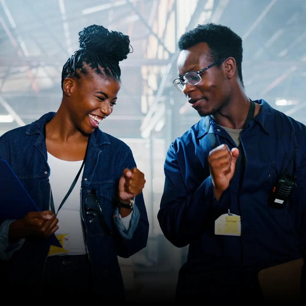 Happy male and female employees laugh together