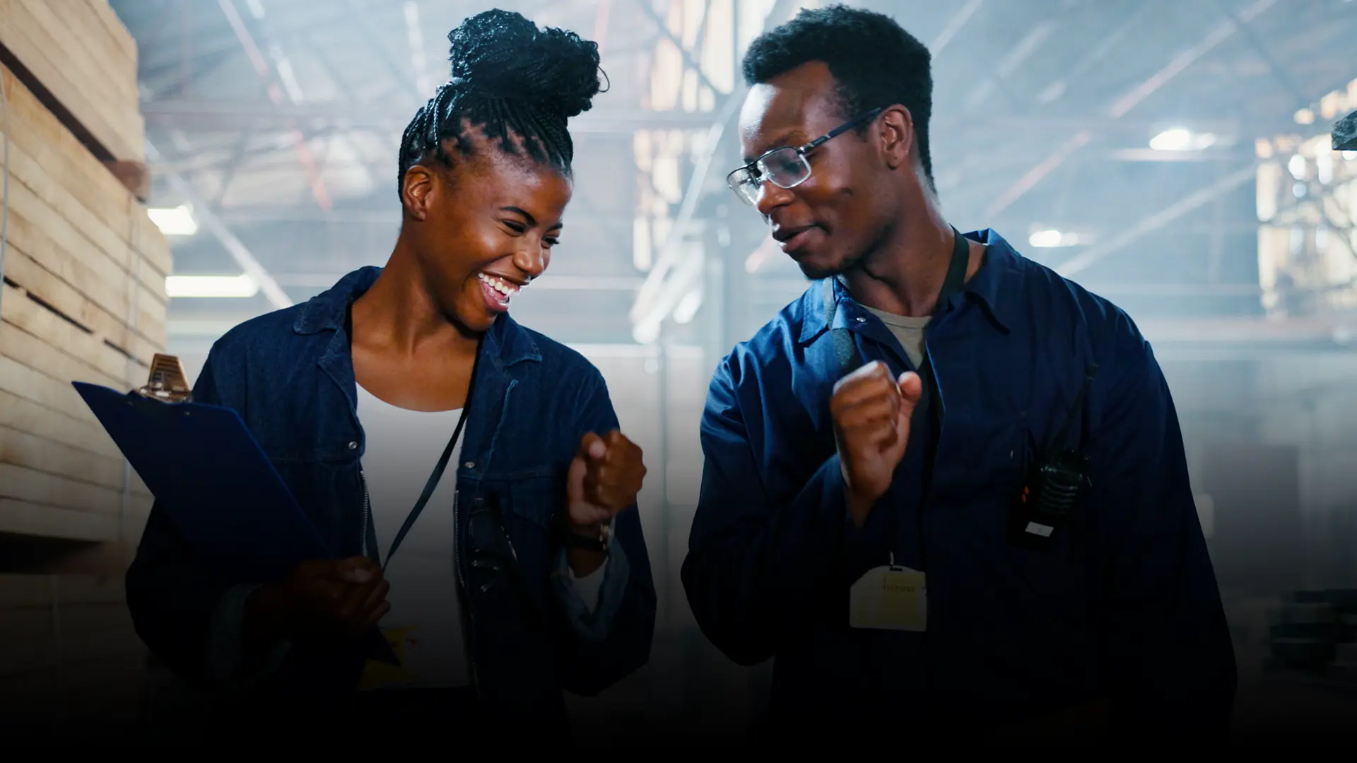 Happy male and female employees laugh together