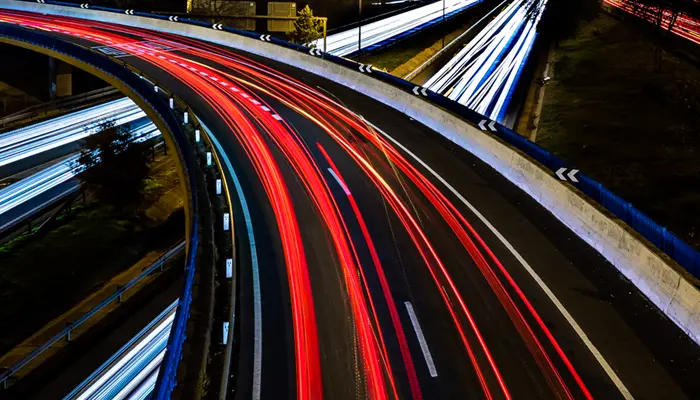 Car headlights and rear lights passing in opposite directions on a motorway