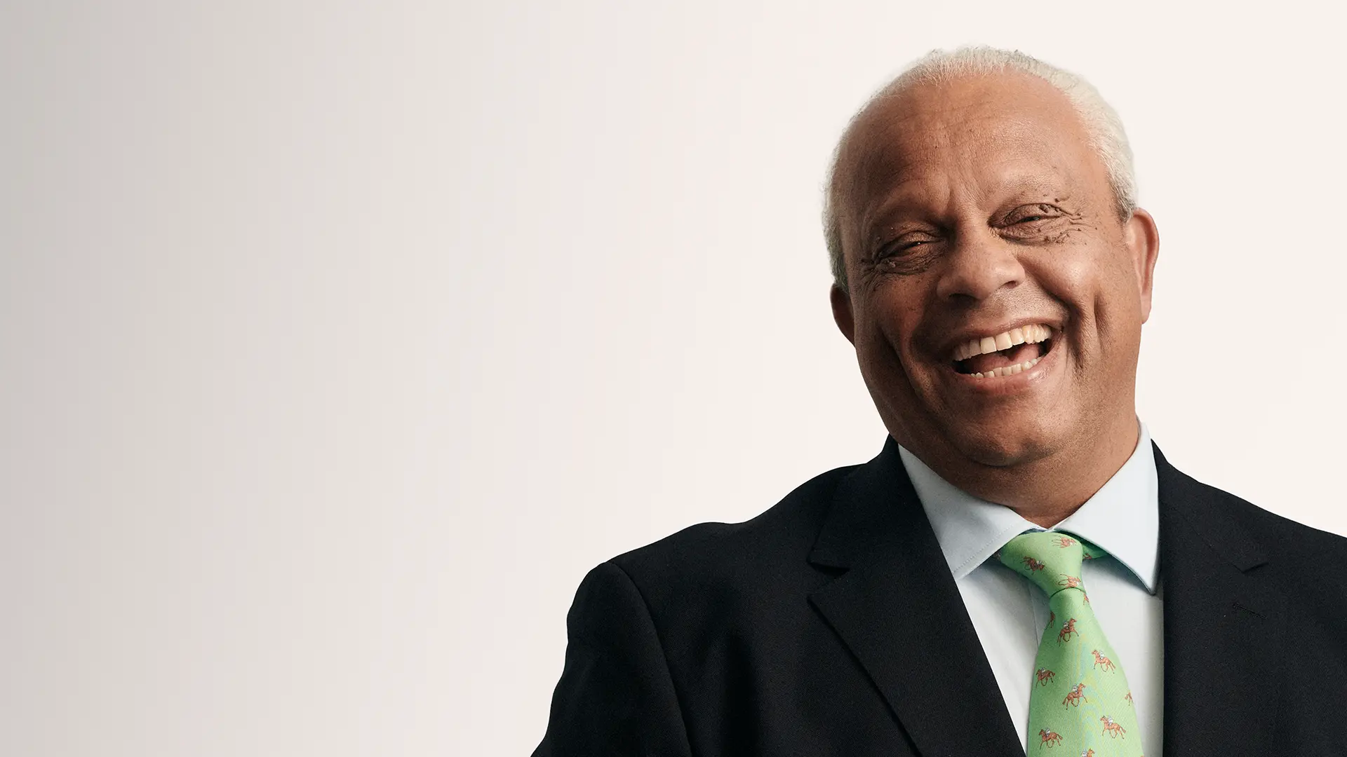 Portrait of Lord Dr Michael Hastings laughing, one of the contributors to The Educators film series with Capita.