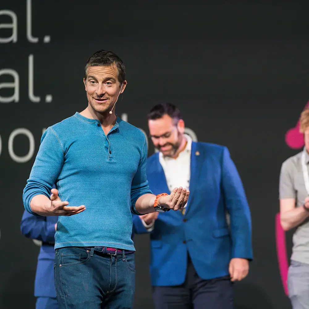 Bear Grylls holding maggots as he appears as a guest speaker at a BecomingX corporate training session.