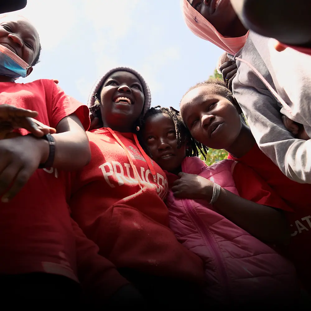 Kenyan children laughing, a photo from the BecomingX Foundation social impact project in Kenya.