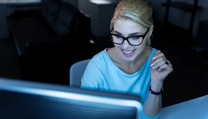 Image of a female employee looking at a screen and having a remote mentoring call 