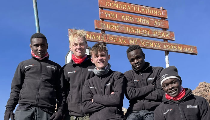 A group of students who have made it to the top of Mount Kenya on a BecomingX Education expedition.