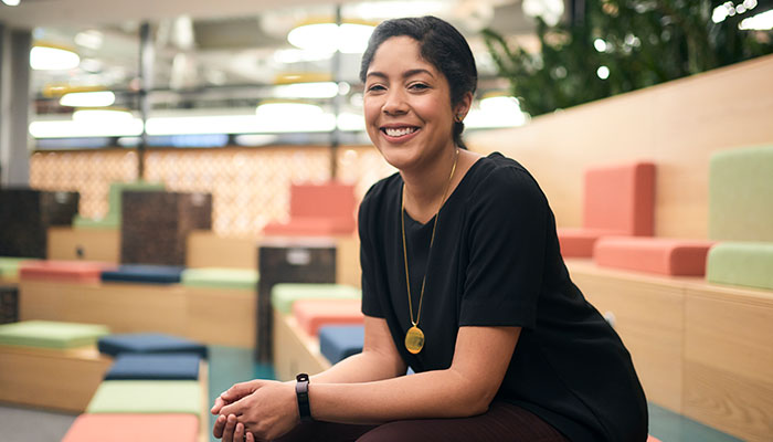 An employee at Amazon sat leaning forward telling a story on camera.